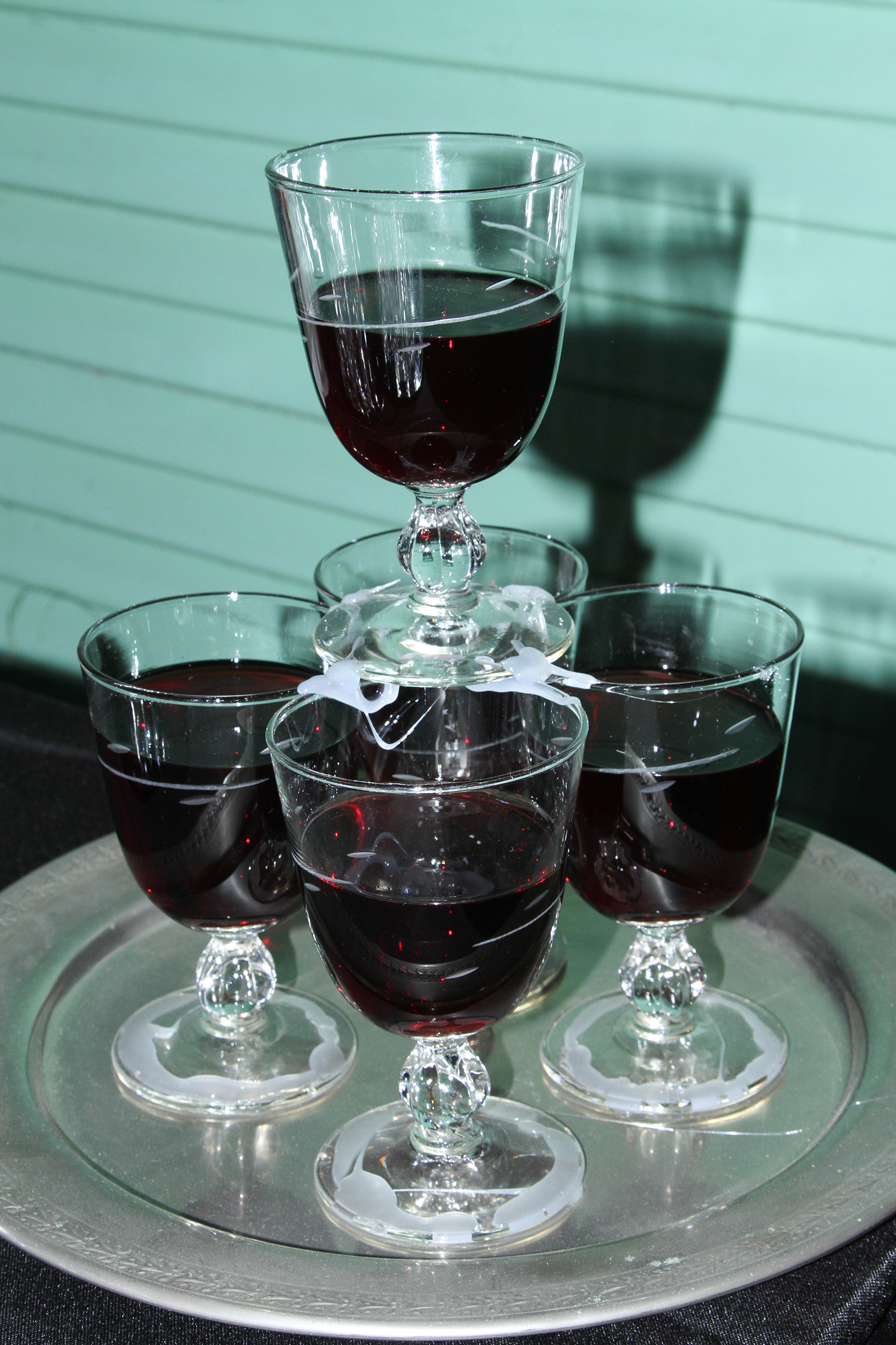 Tower of red wine glasses on a silver tray